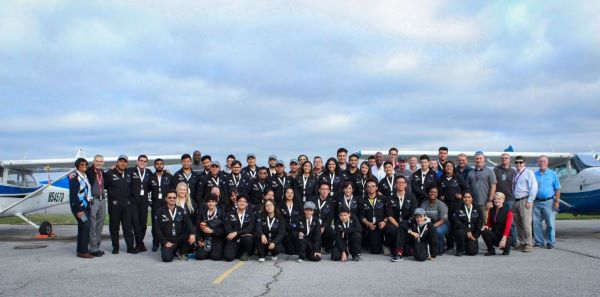 Group photo showing Revolution Flight School hosting international Space Camp students at Huntsville International Airport