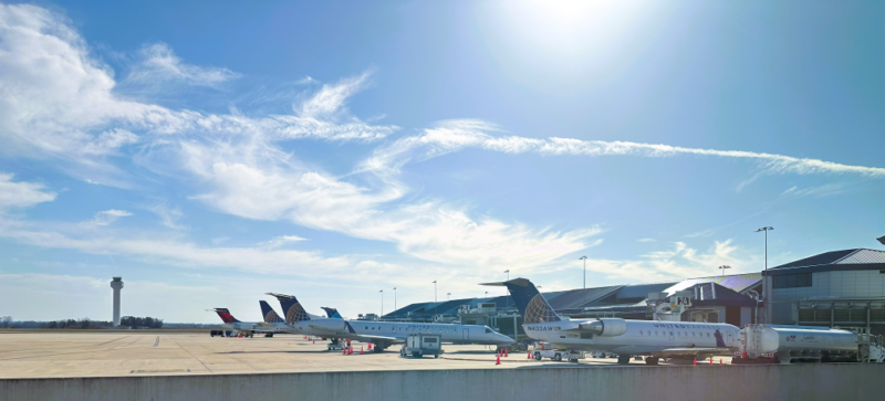 Five airplanes lined up at Huntsville International Airport terminal